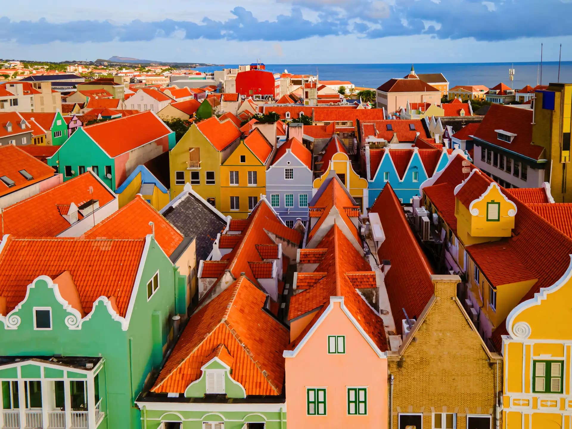 Orange-tiled roofs and pastel Dutch-colonial gables packed together in Punda, Willemstad, Curaçao
