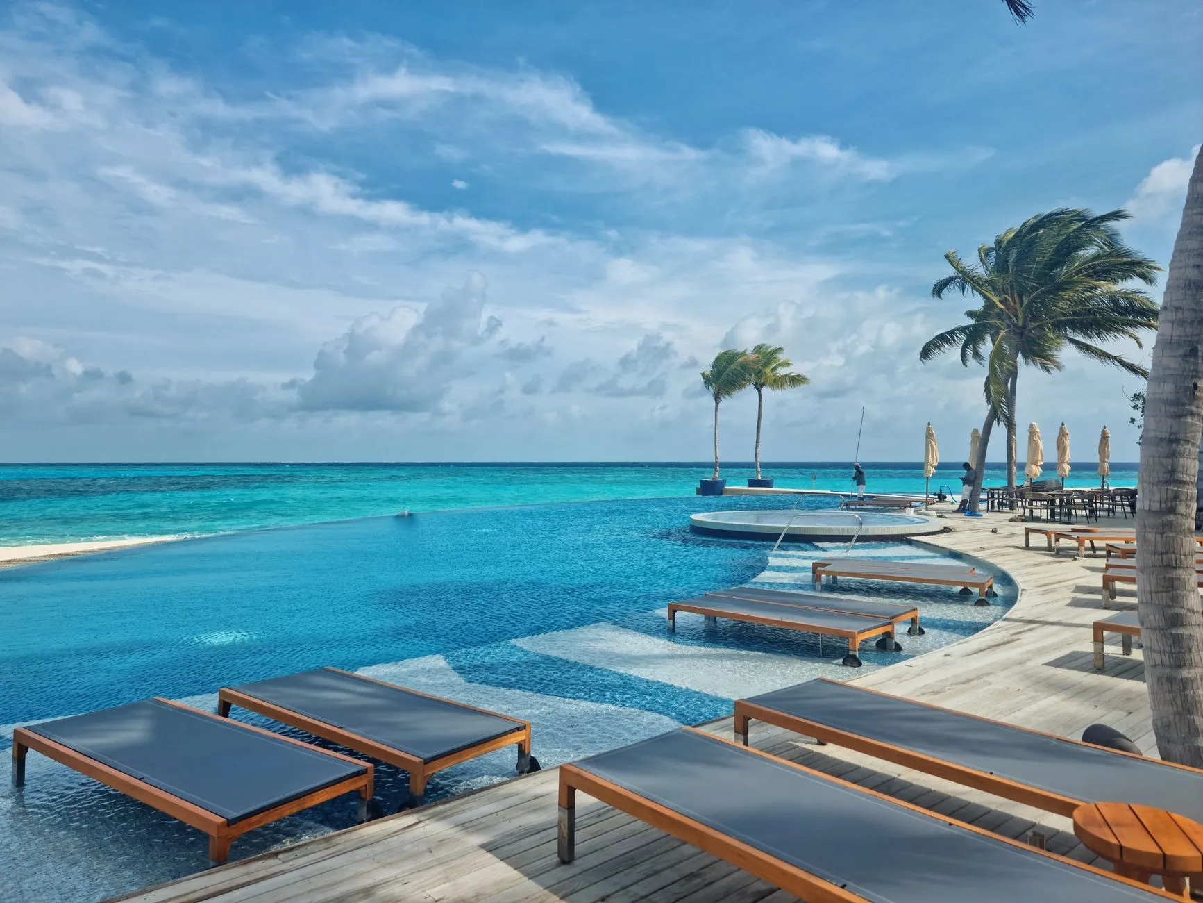 Oceanfront Caribbean resort pool at golden hour